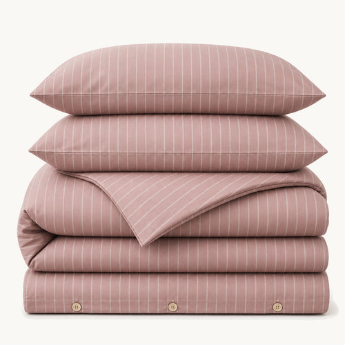 Stacked Mocha Stripe cotton sateen bedding set on a warm off-white background