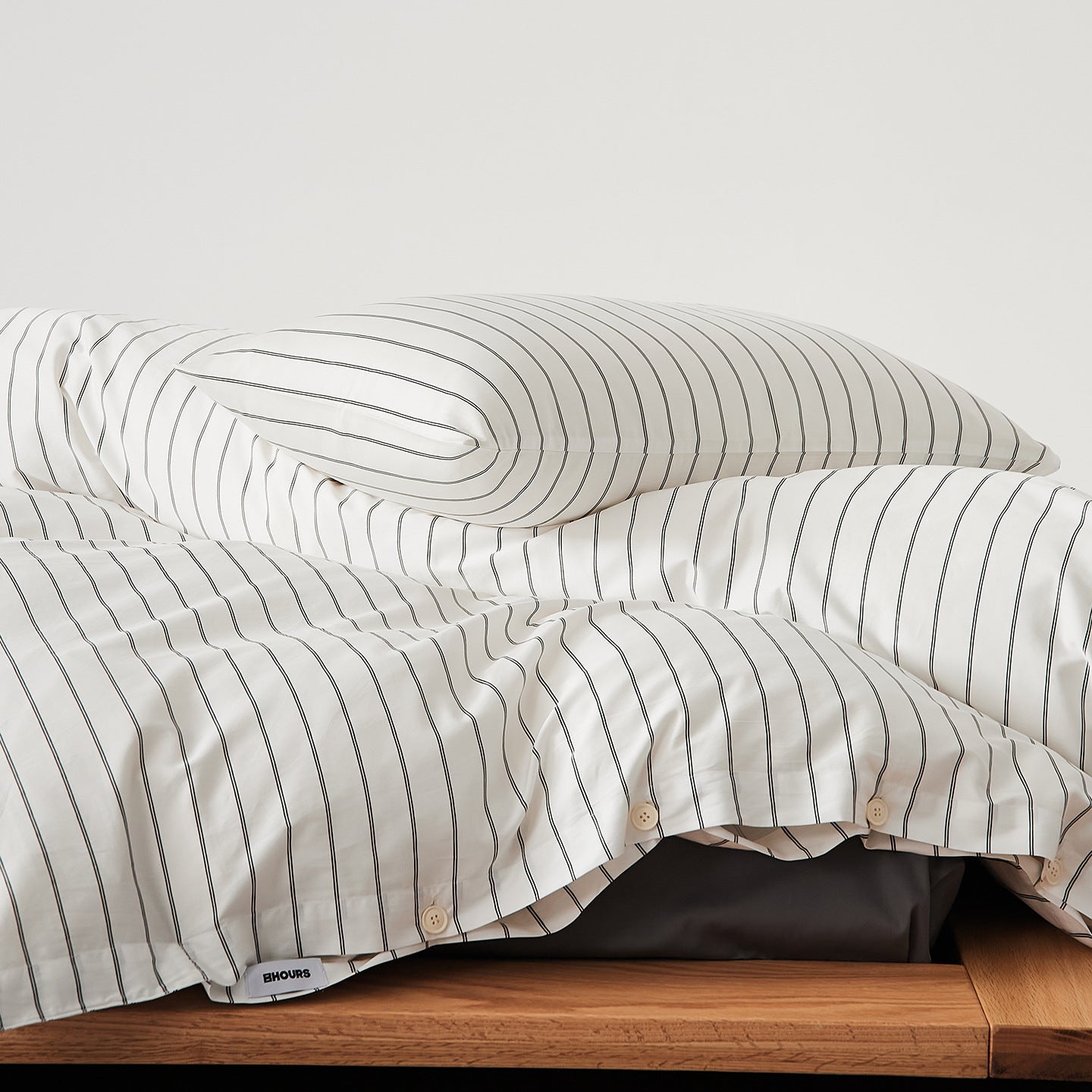White Stripe cotton sateen bedding set styled on a bed