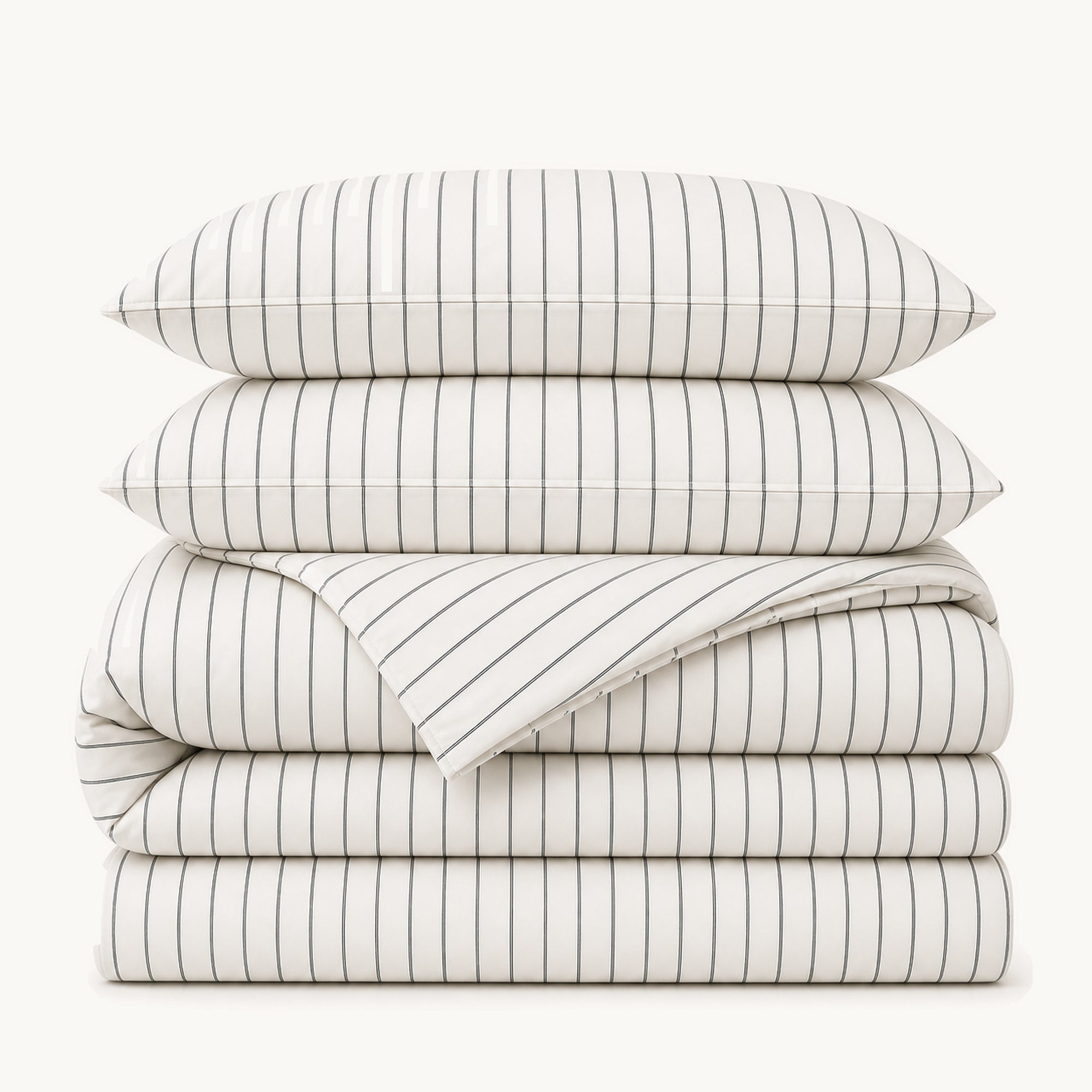 Stacked White Stripe cotton sateen bedding set on a warm off-white background