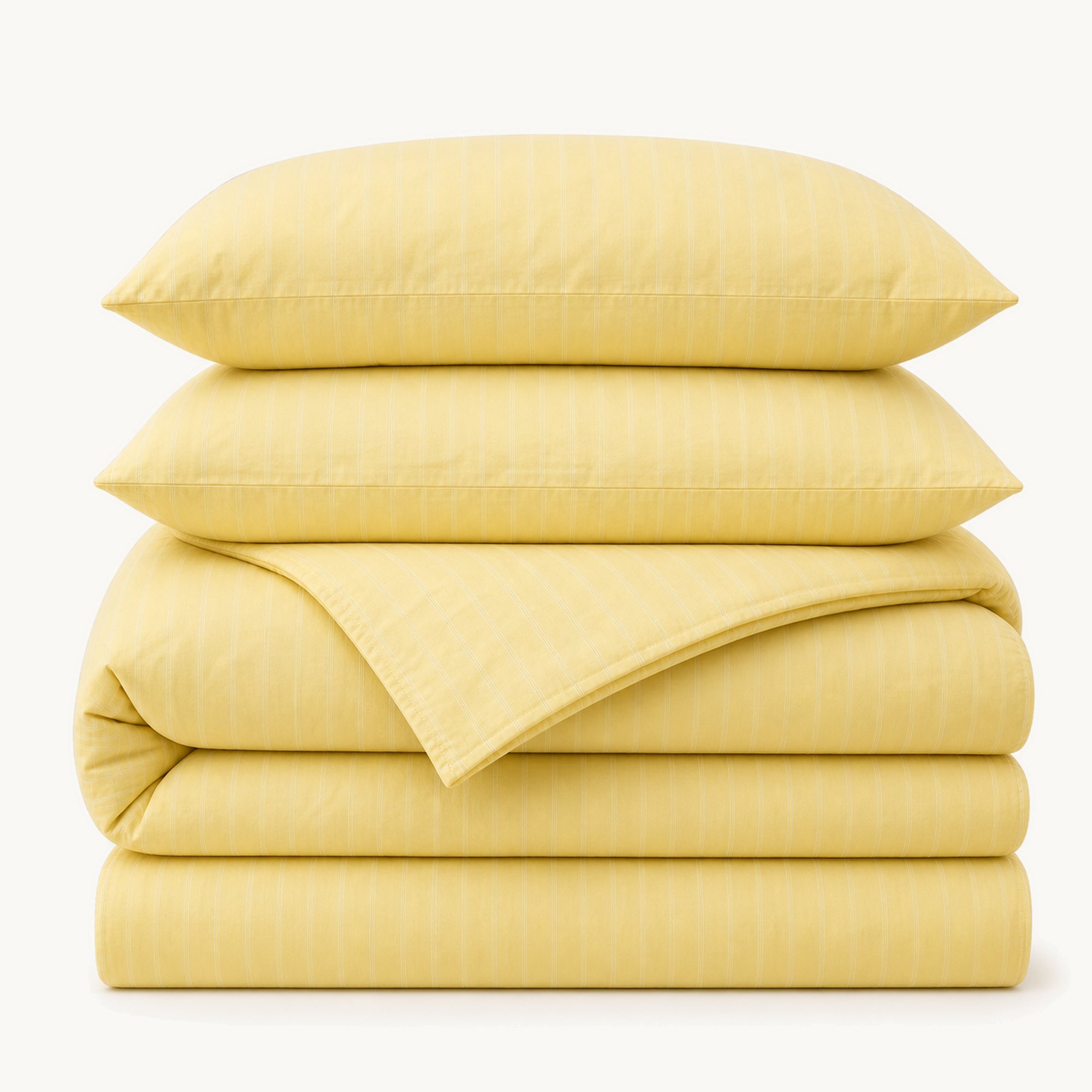Stacked Yellow Stripe cotton sateen bedding set on a warm off-white background